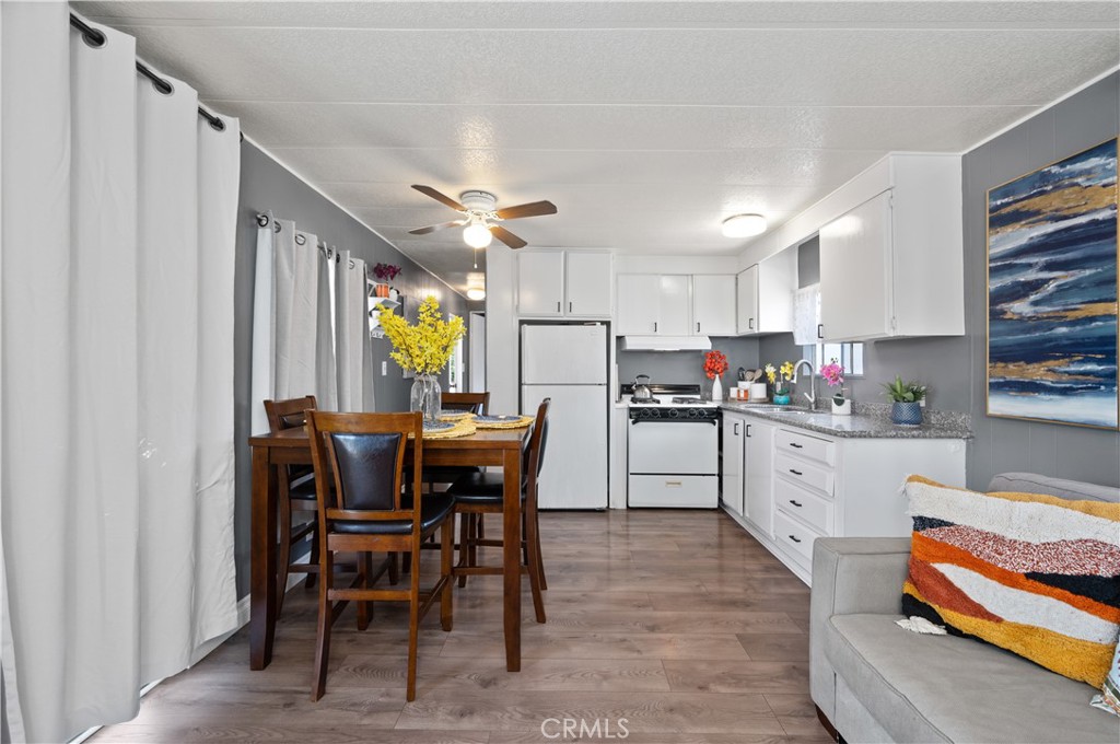 a kitchen with a dining table chairs and cabinets