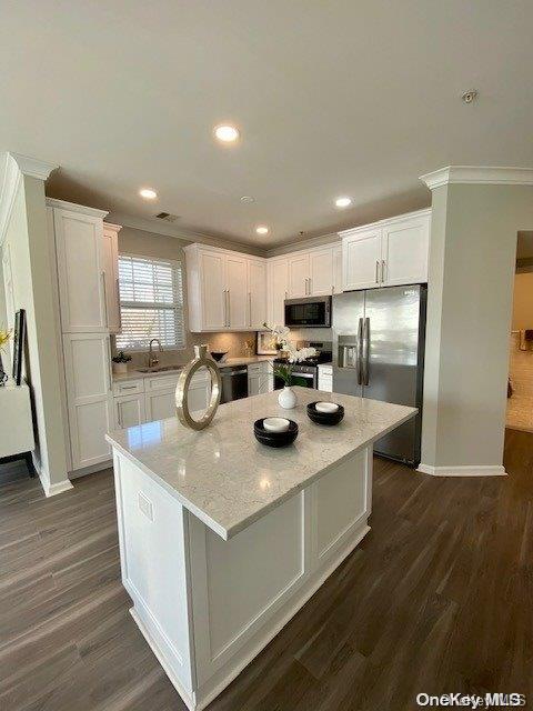 a kitchen with refrigerator and cabinets