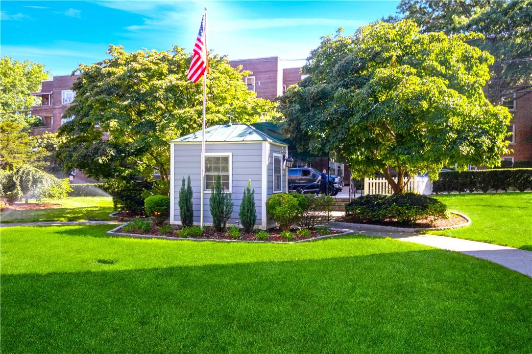 a front view of a house with a yard and fountain