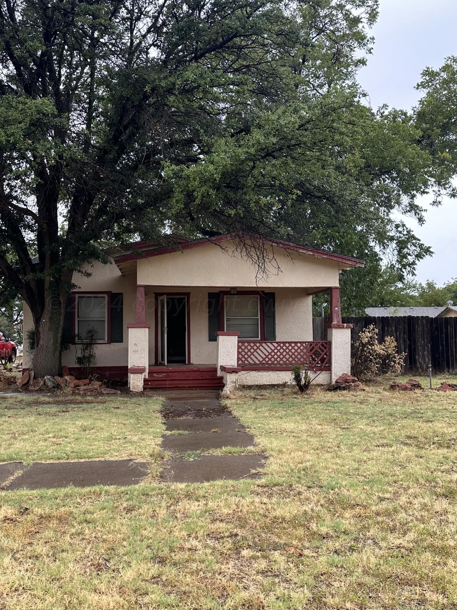 a view of a house with a patio and a yard