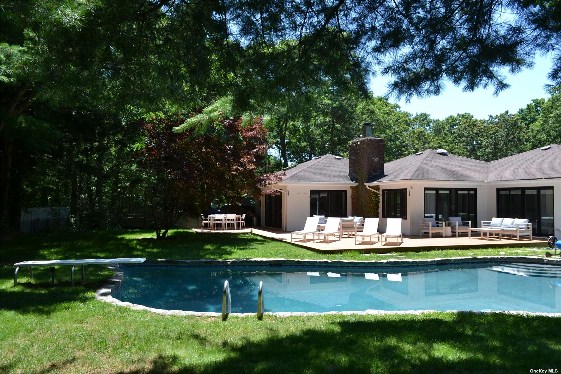 a view of a house with swimming pool and a yard