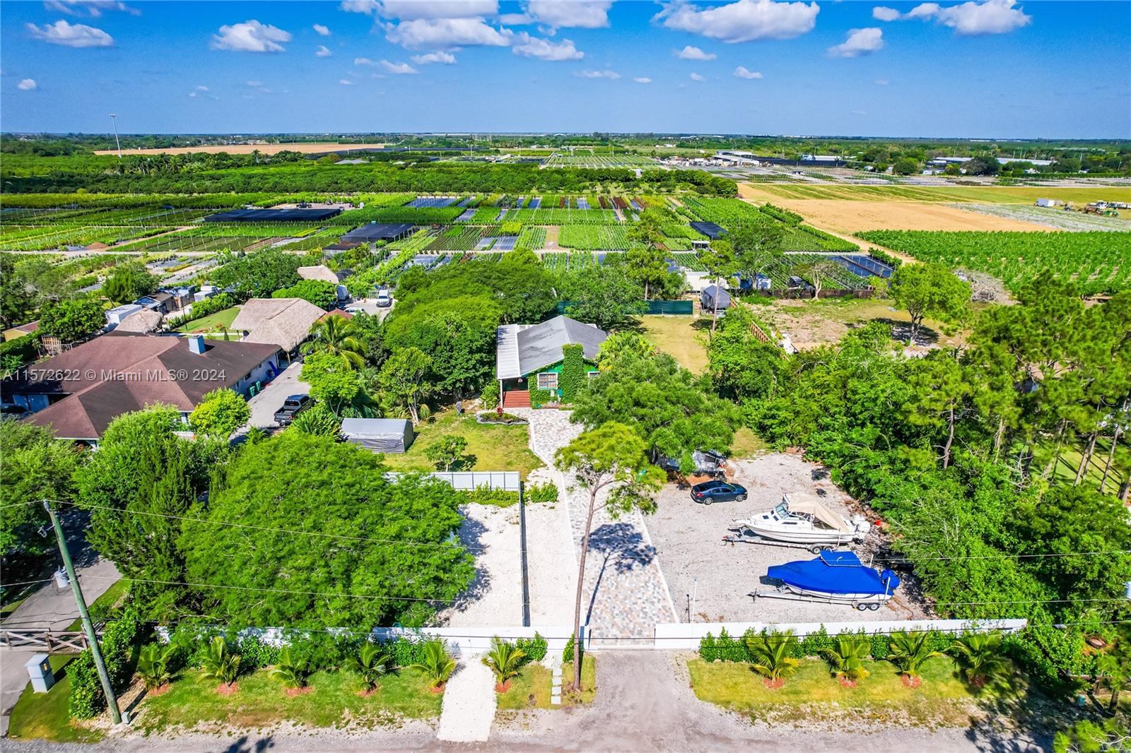 an aerial view of ocean residential houses with outdoor space and trees