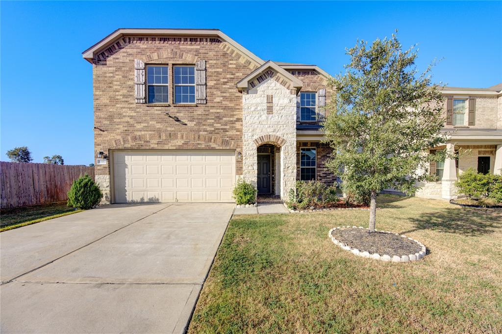 This charming two-story home showcases a perfect blend of modern design and classic appeal. Large windows allow natural light to flood the interior, highlighting the spacious rooms.