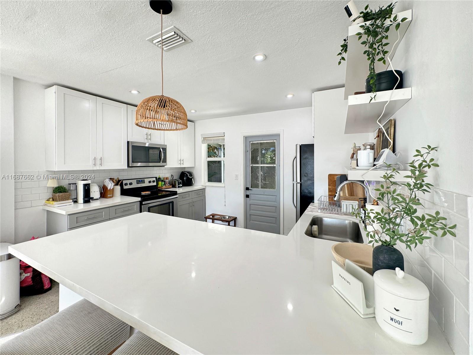 a large white kitchen with lots of counter space