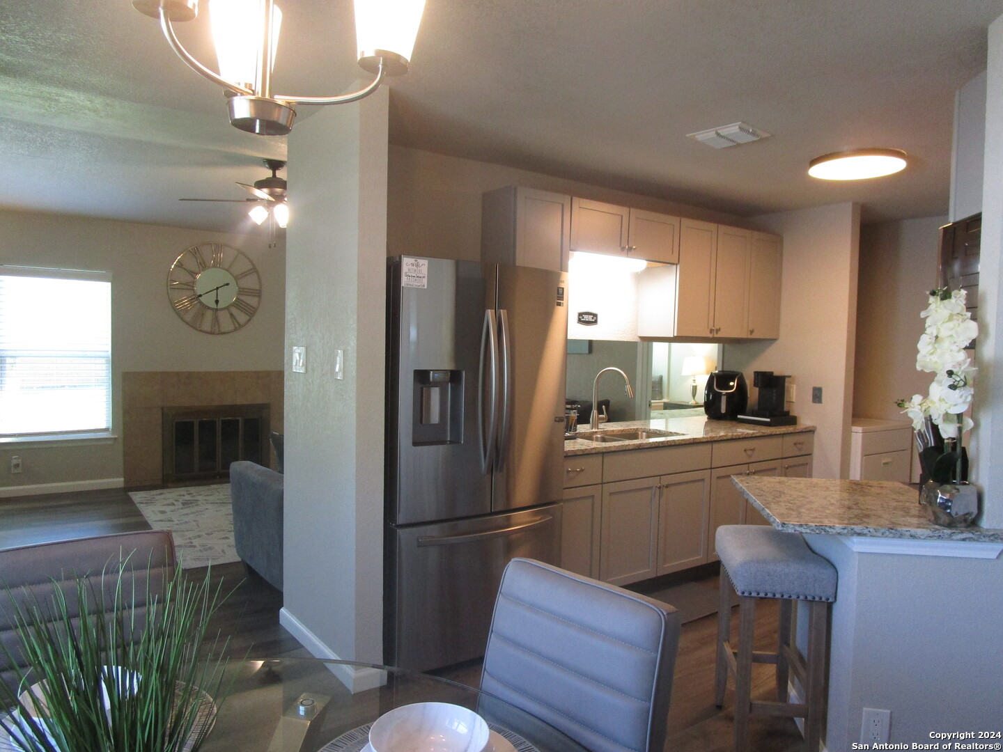 a kitchen with stainless steel appliances granite countertop a refrigerator and a stove top oven