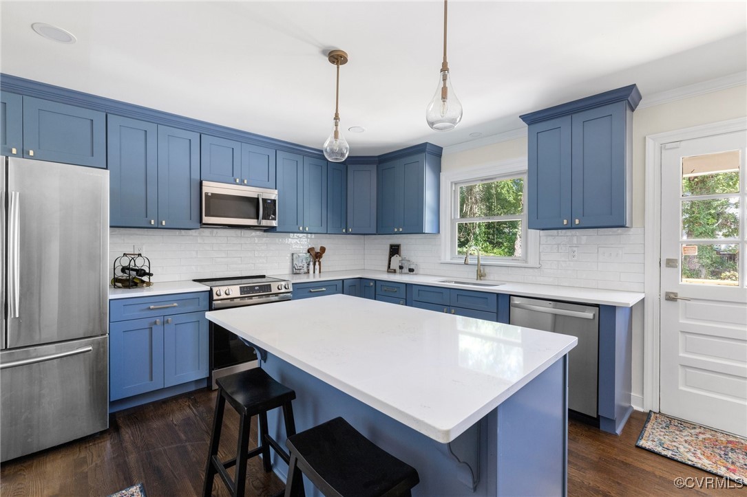 a kitchen with kitchen island a wooden table and chairs