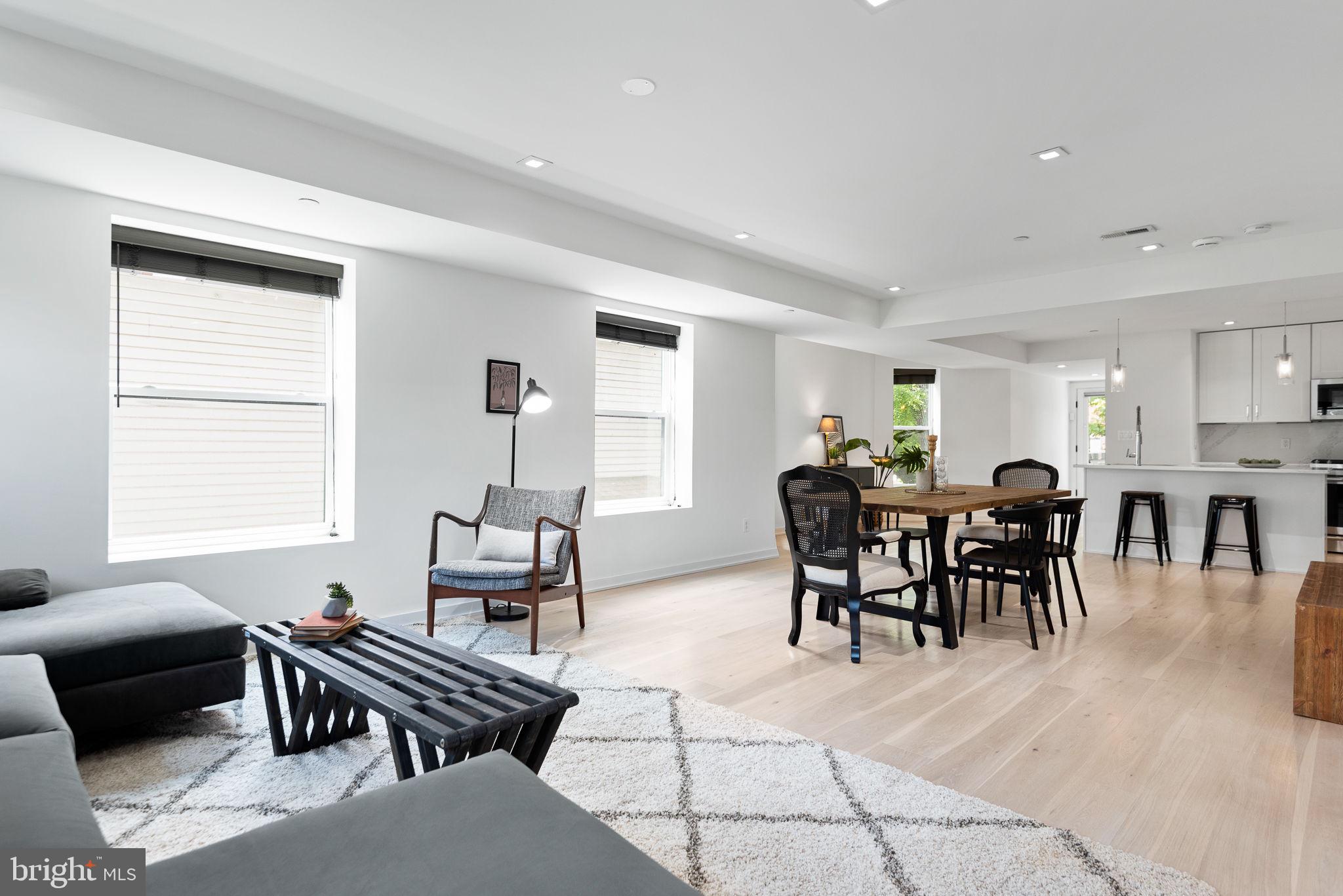 a living room with furniture a dining table and a window