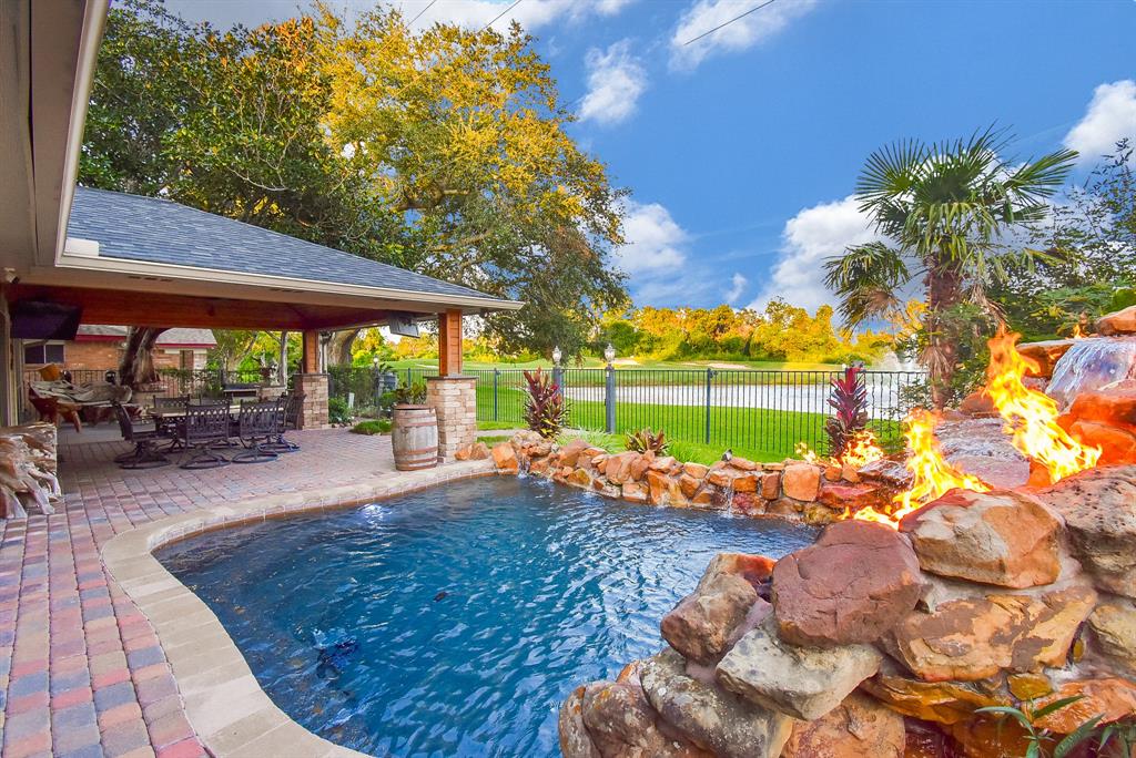 a view of a backyard with sitting area