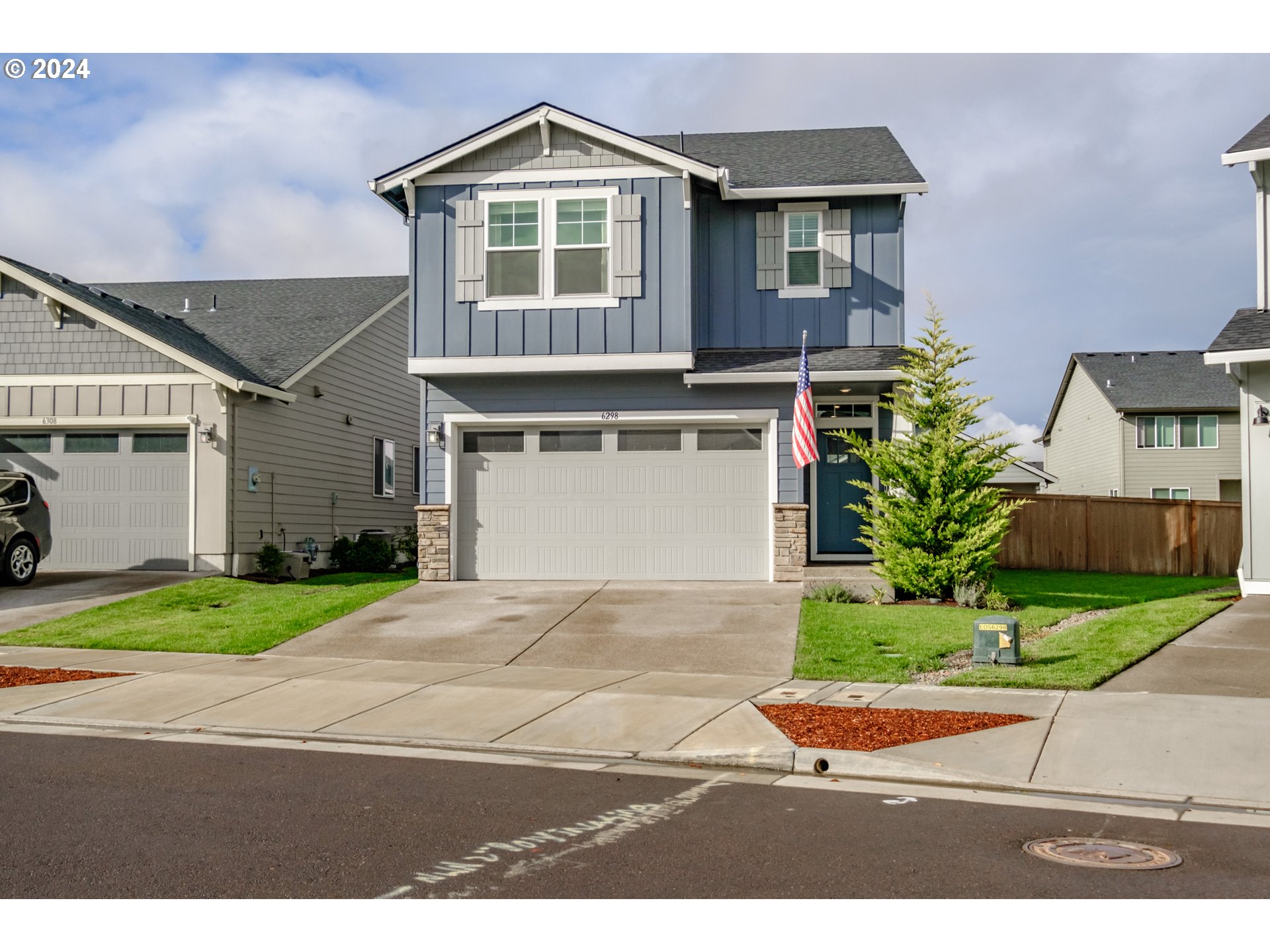 a front view of a house with a yard and a garage