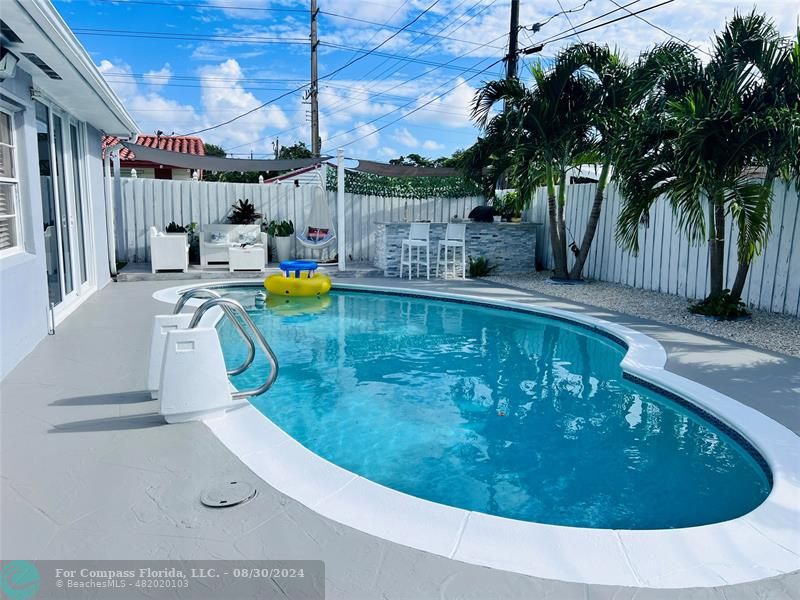 a view of a swimming pool with a patio