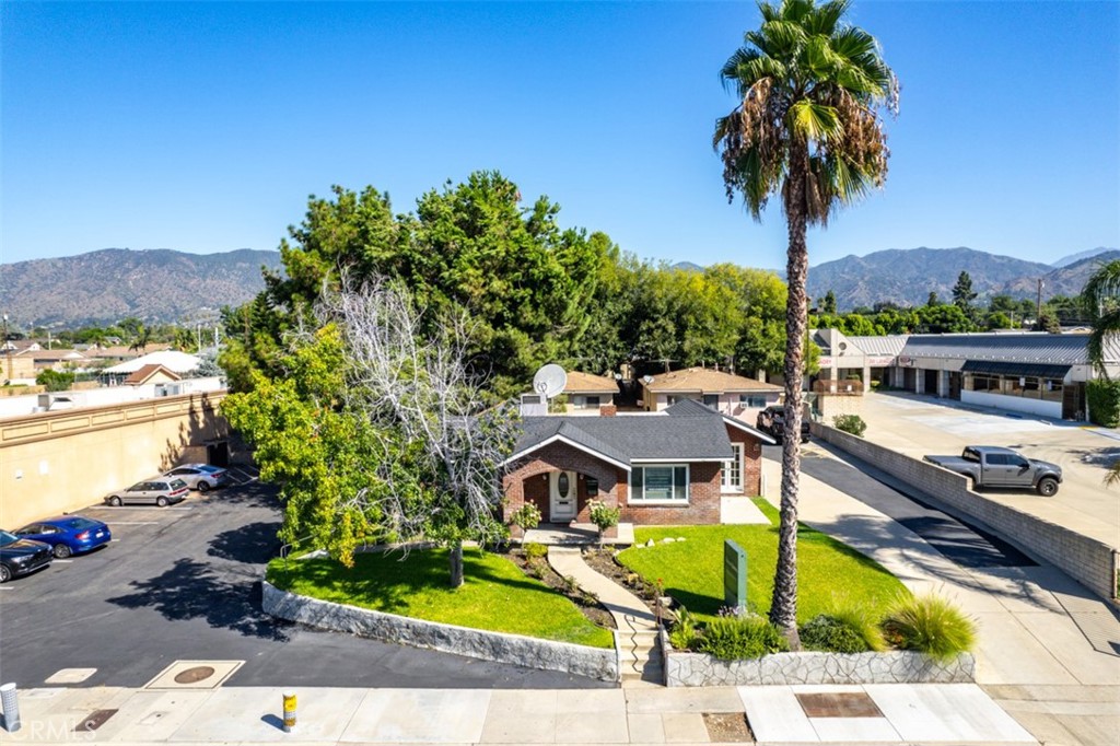 an aerial view of a house with swimming pool garden and mountain view