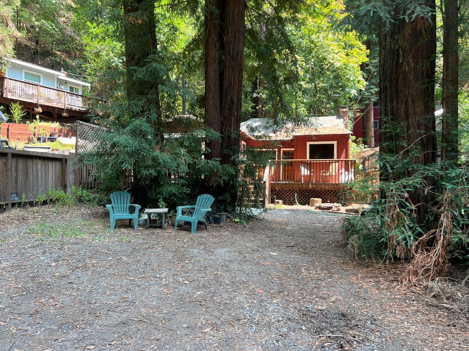 a view of backyard with table and chairs and a large tree