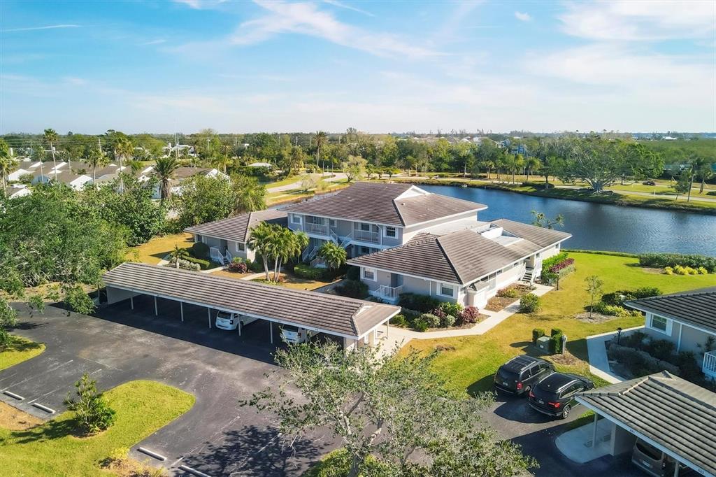 an aerial view of a house with swimming pool and lake view