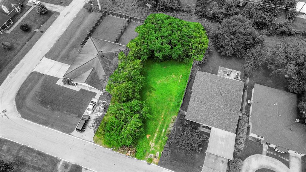 an aerial view of a house with garden space and street view