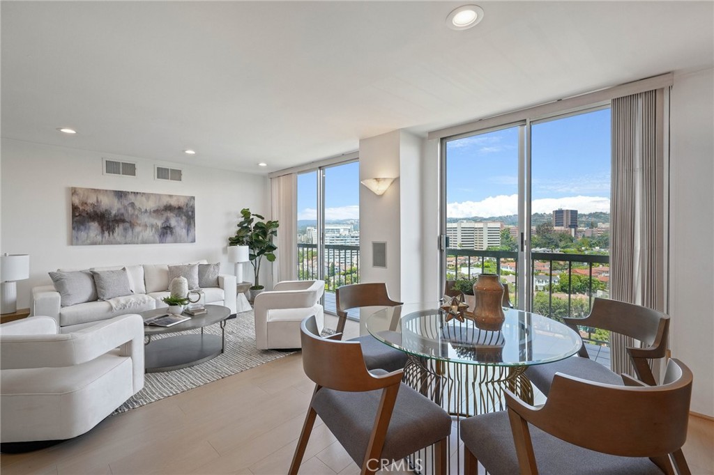 a living room with furniture and a floor to ceiling window