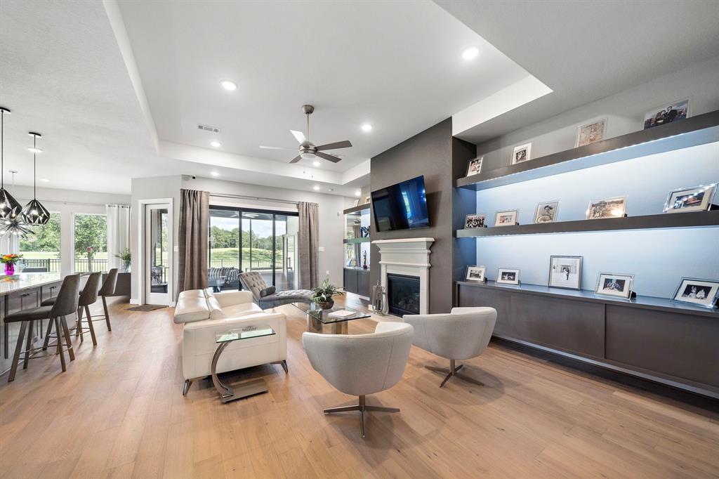 a living room with furniture a fireplace and a large window