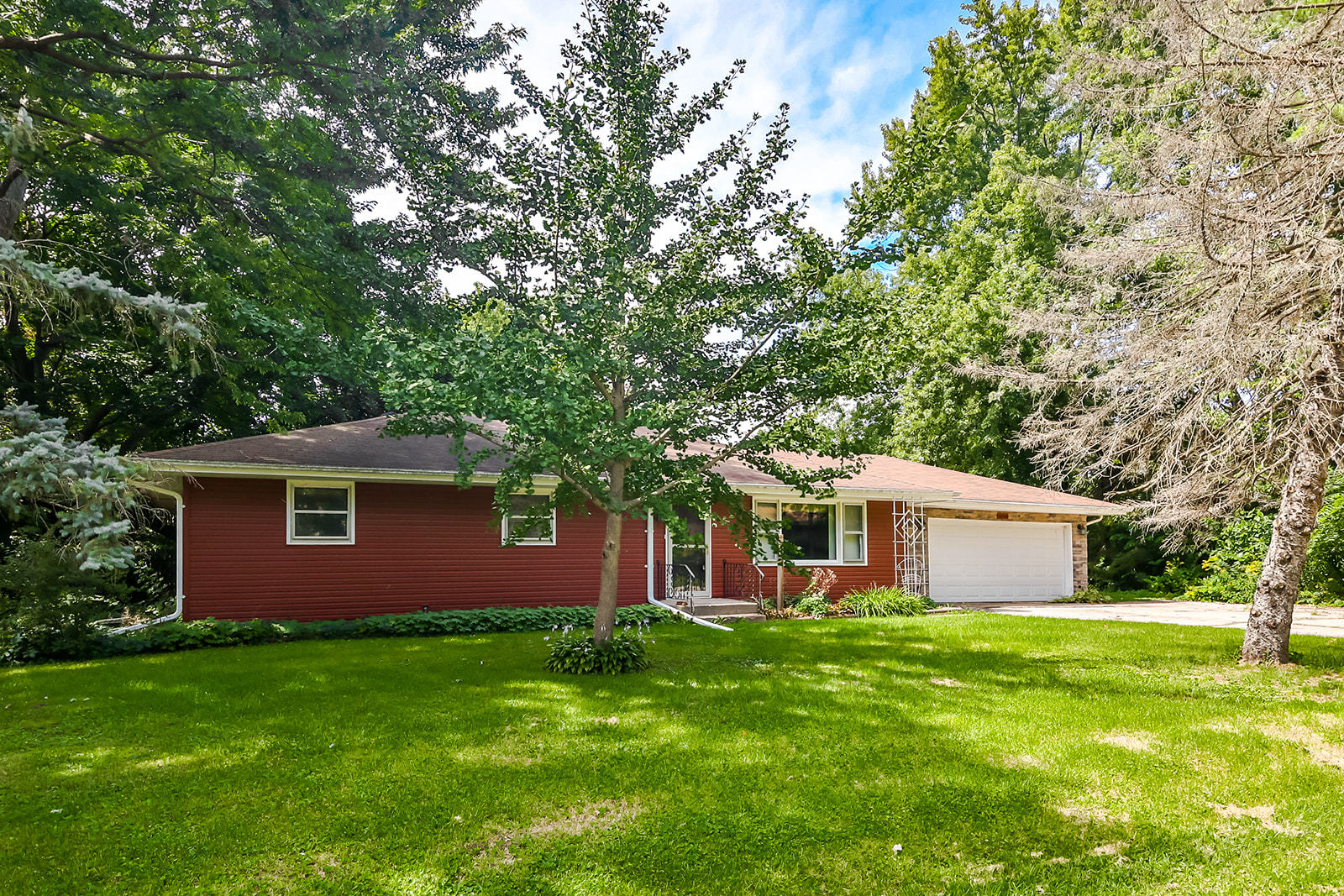 a front view of house with yard and green space