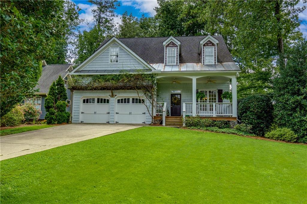 a front view of a house with a garden