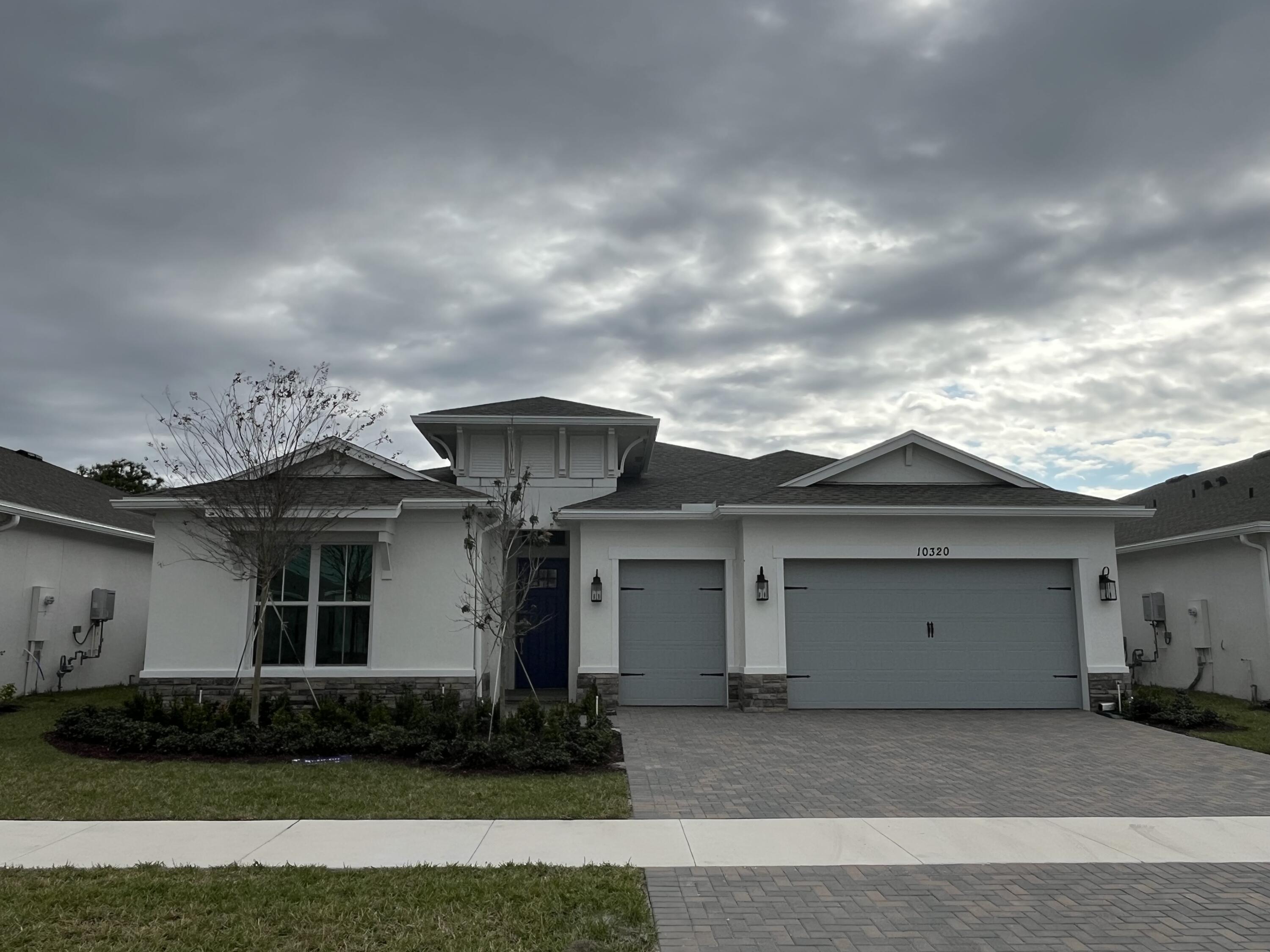 a front view of a house with garden