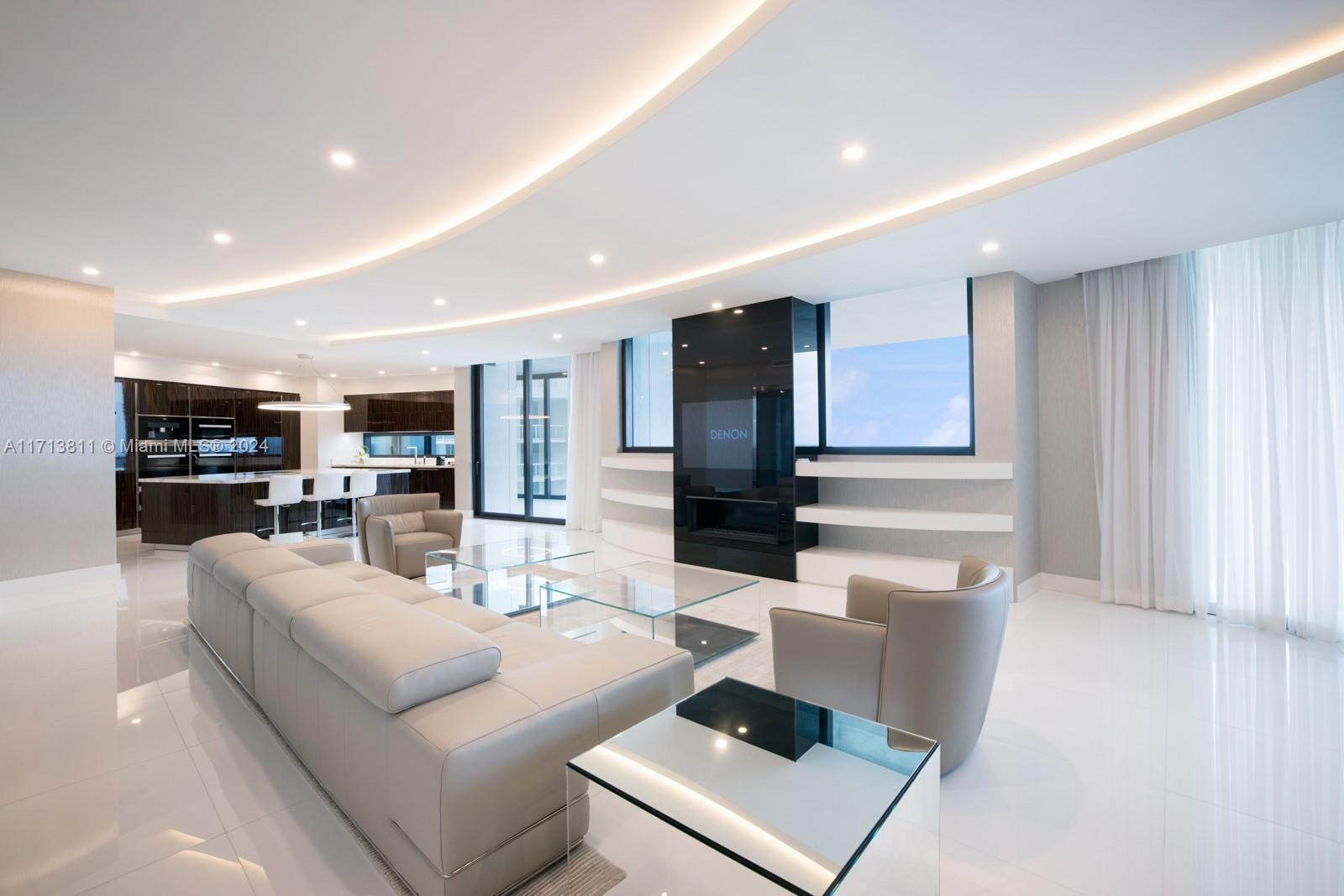 a living room with furniture and view of kitchen