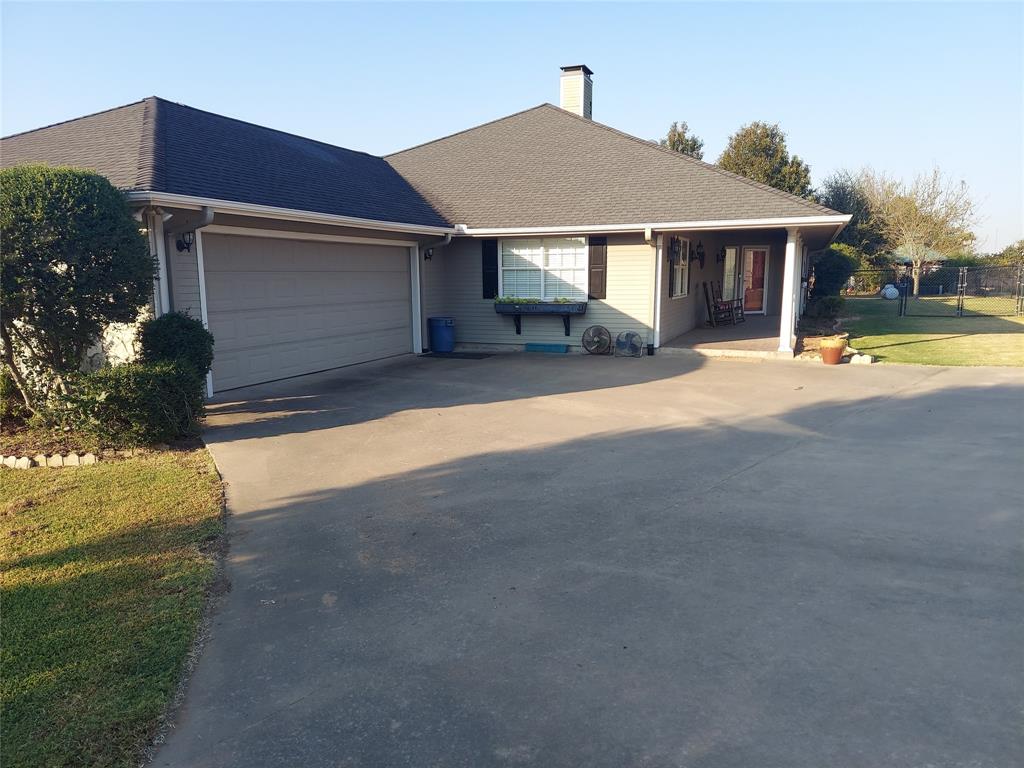 a front view of a house with a yard and outdoor seating