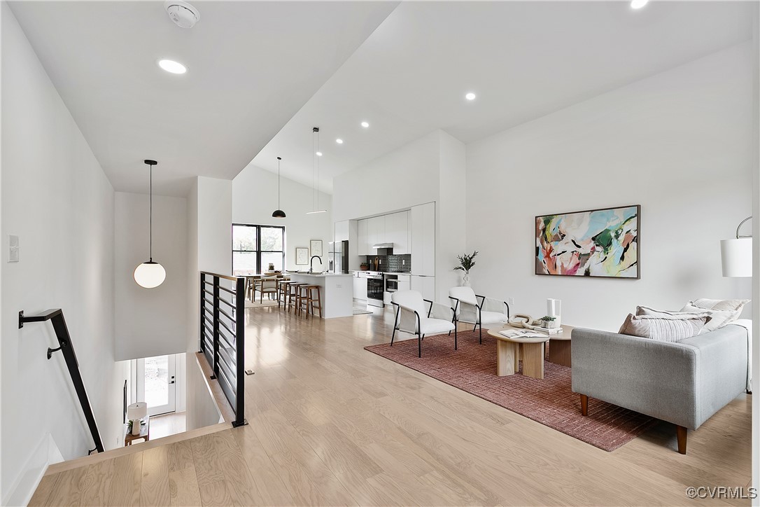 a living room with furniture and a wooden floor