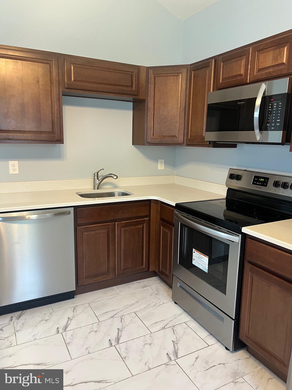 a kitchen with a sink and a stove top oven