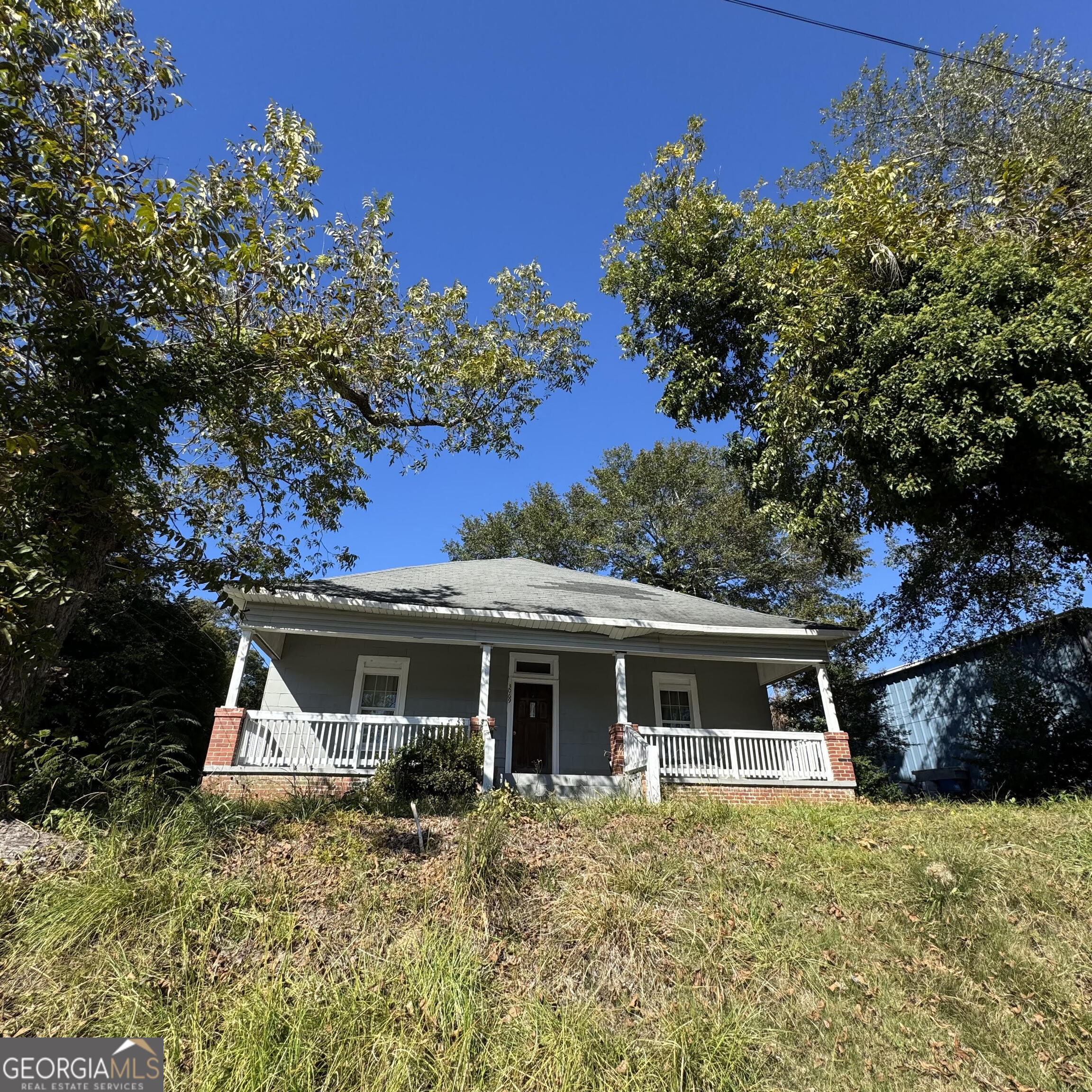 a front view of a house with a garden