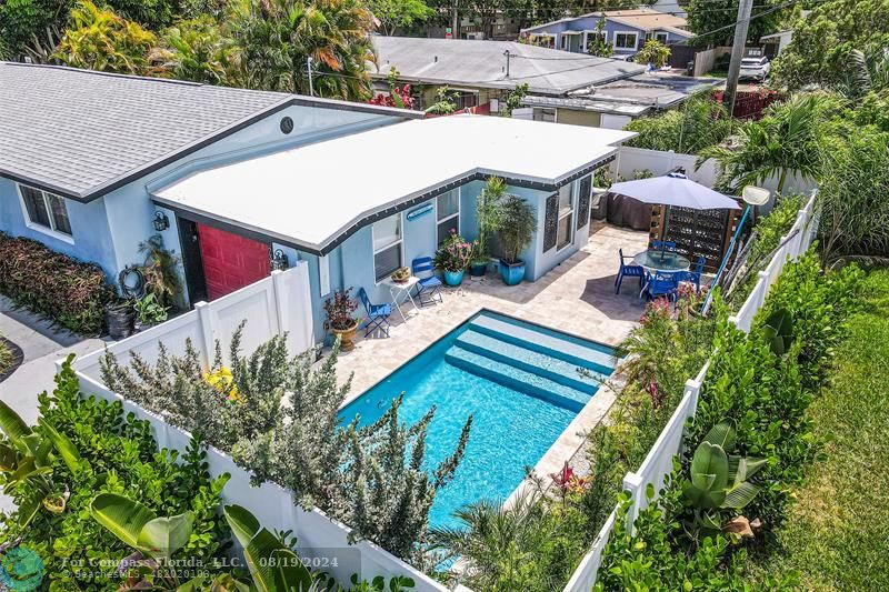 a aerial view of a house with swimming pool and sitting area