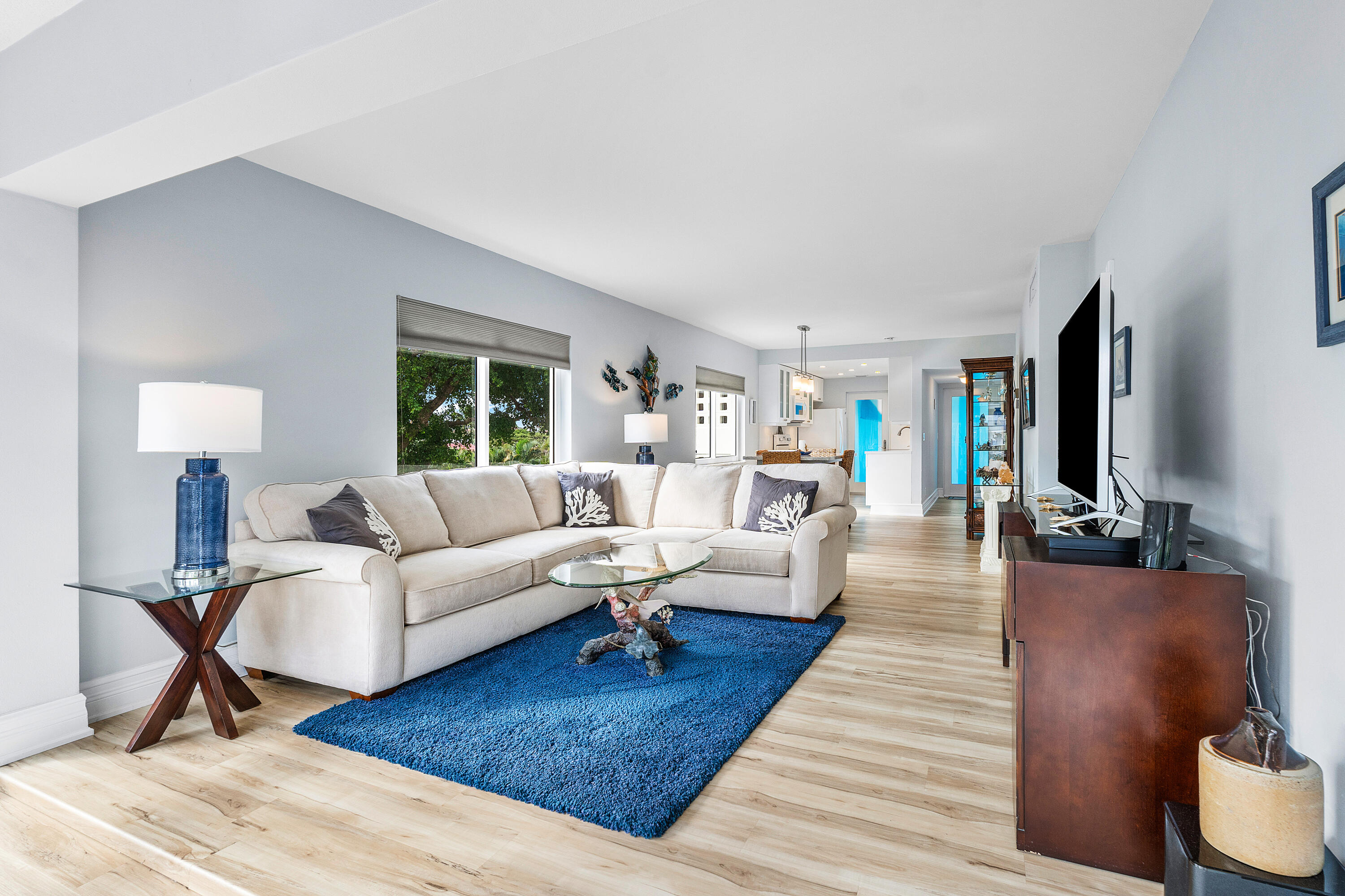 a living room with furniture a lamp and a table