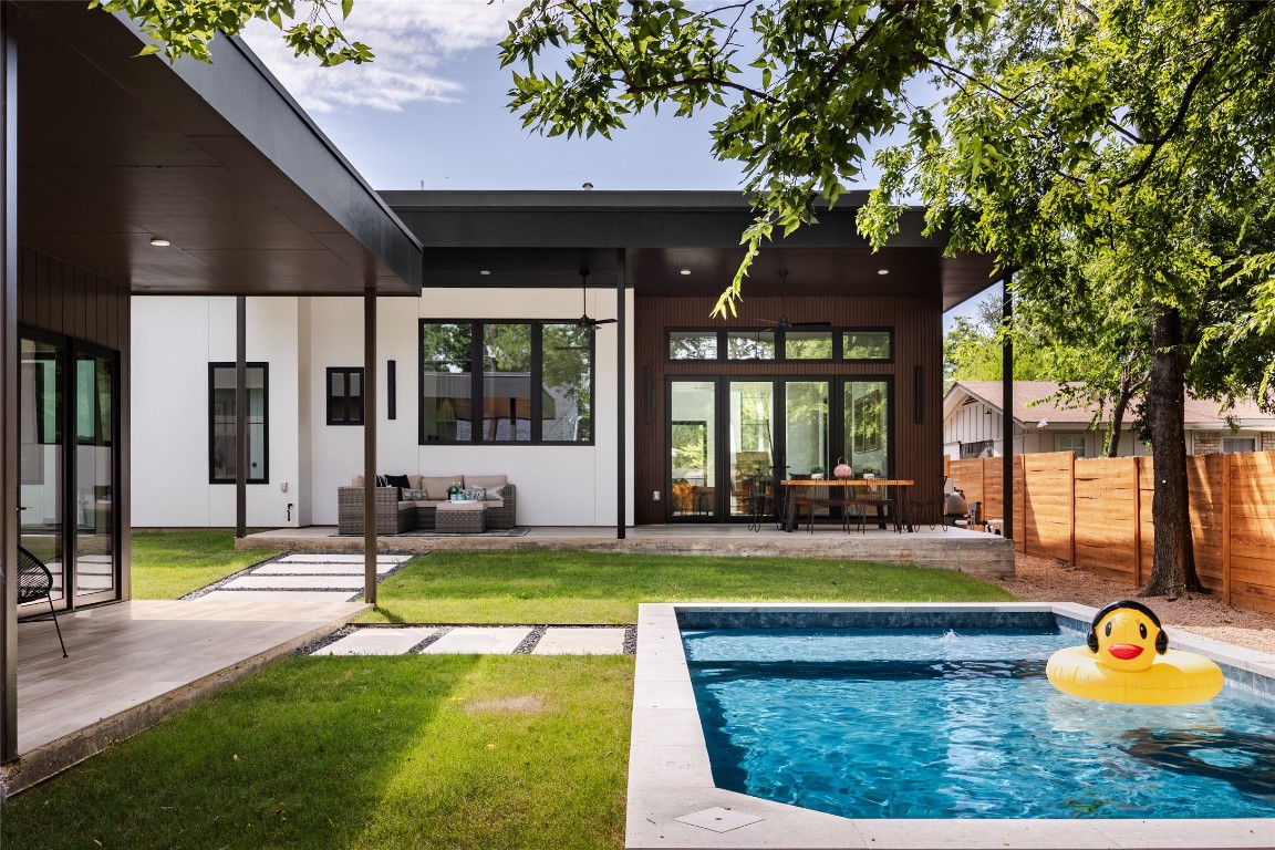 a view of a house with swimming pool and sitting area