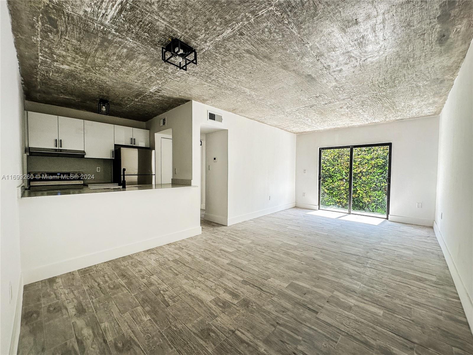 a view of a kitchen with microwave and cabinets