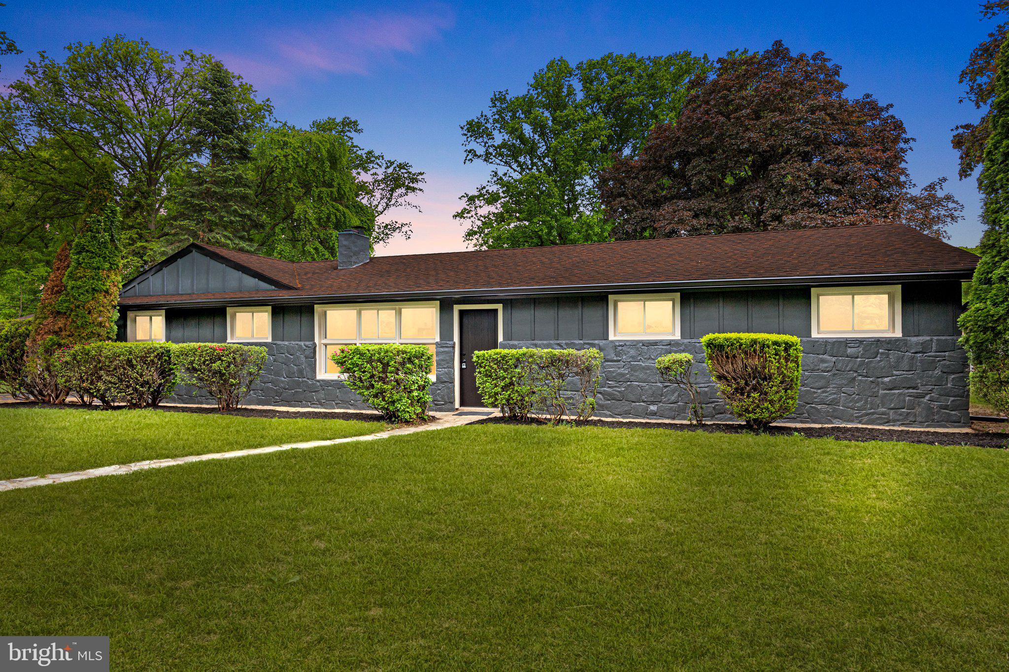 a front view of a house with a garden