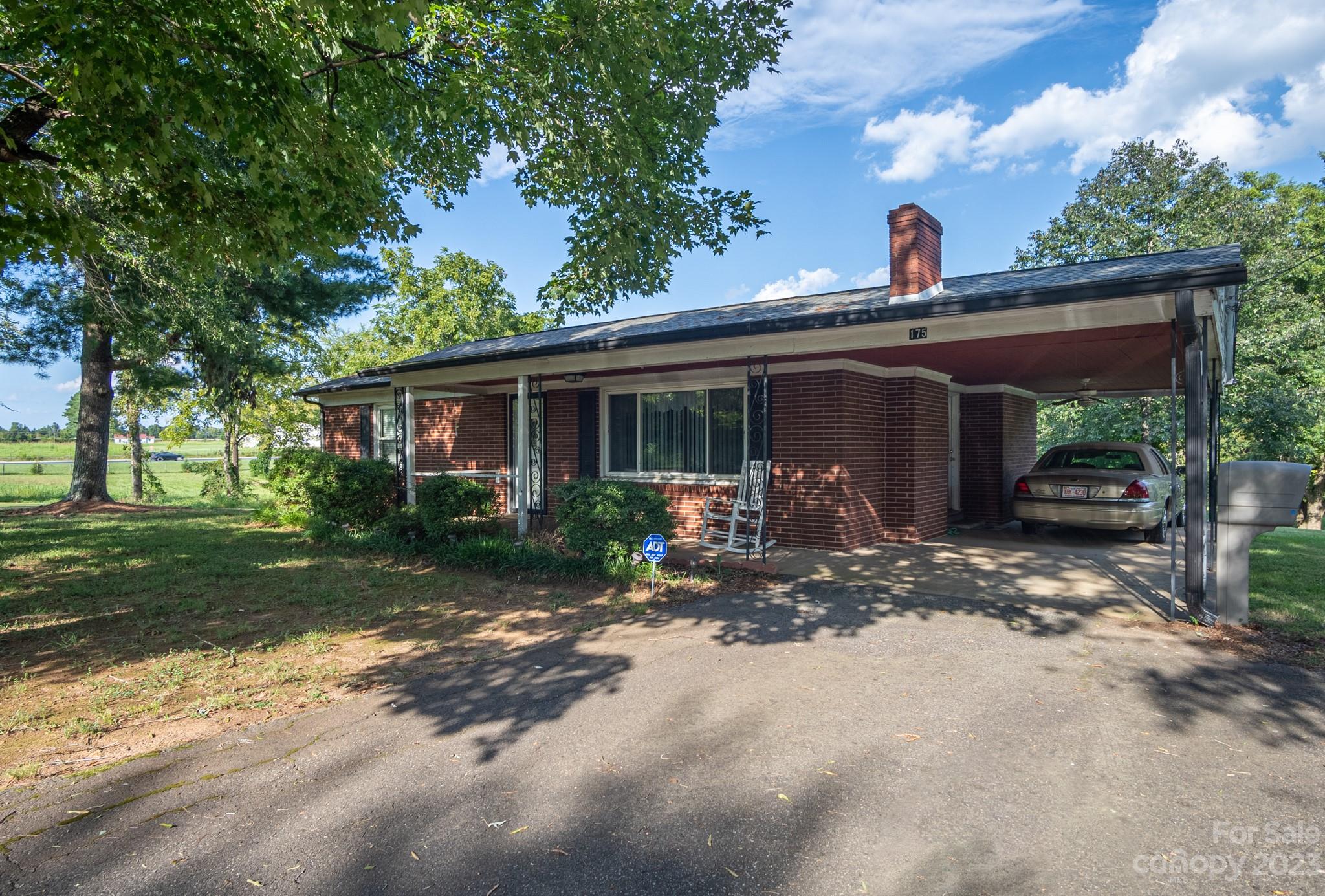 a view of a house with a yard siting area and garden