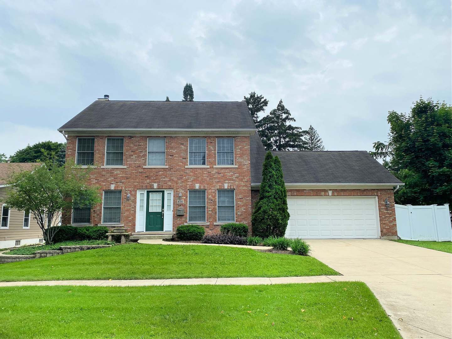 front view of a house next to a yard