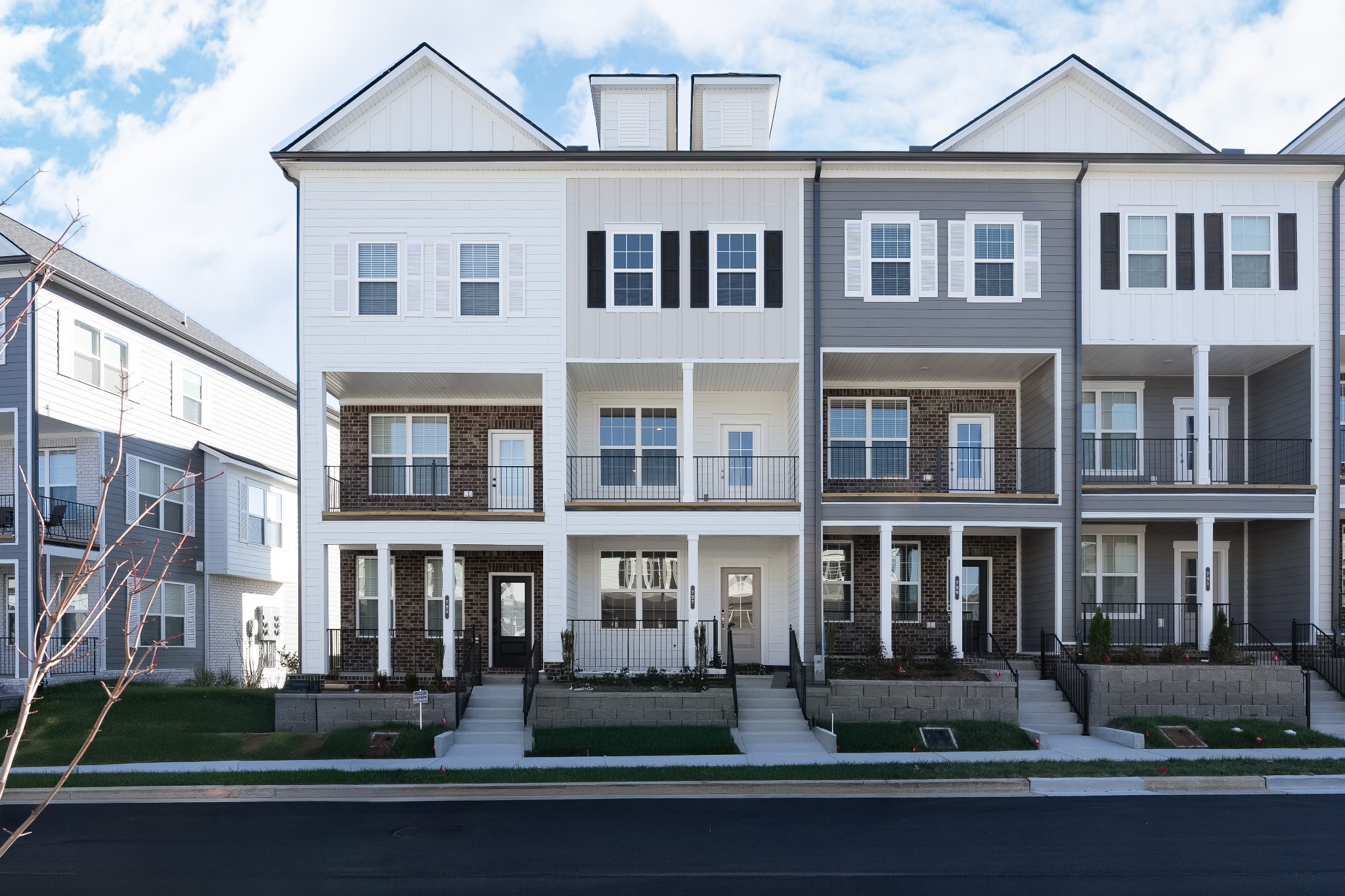 a front view of a residential apartment building with a yard