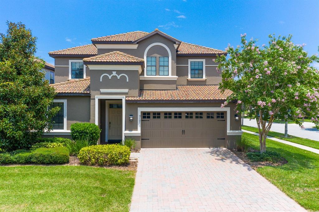 a front view of a house with a yard and garage