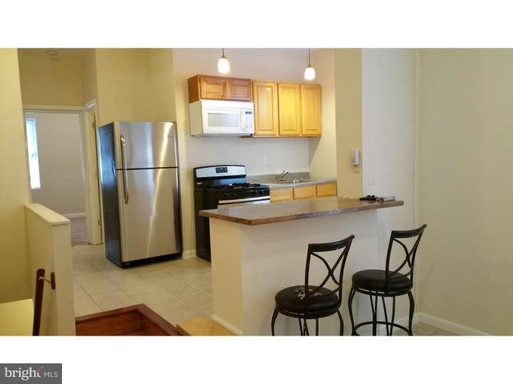 a kitchen with a sink cabinets and refrigerator