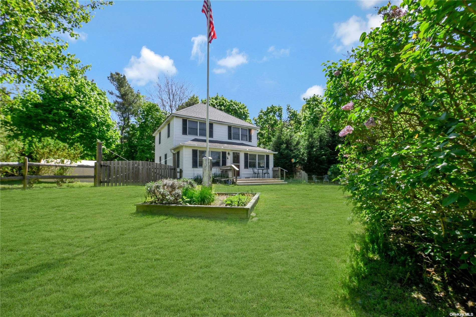 a front view of a house with a yard table and chairs