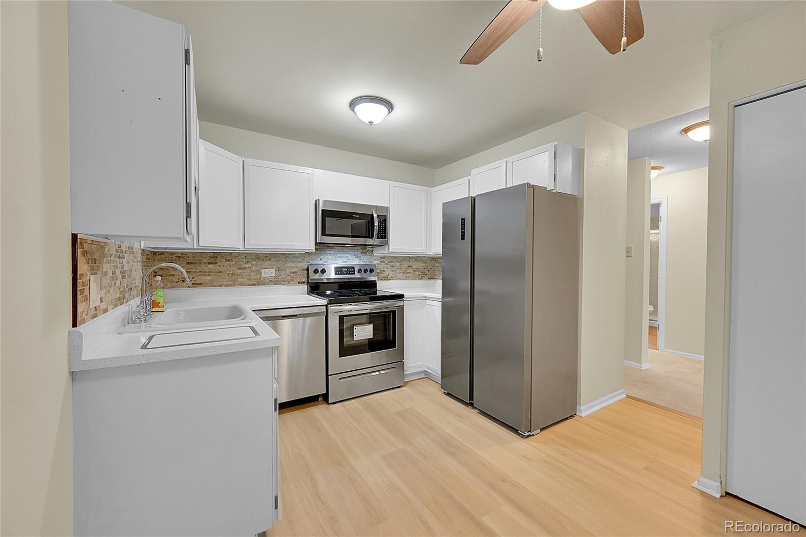 a kitchen with a refrigerator sink and stove