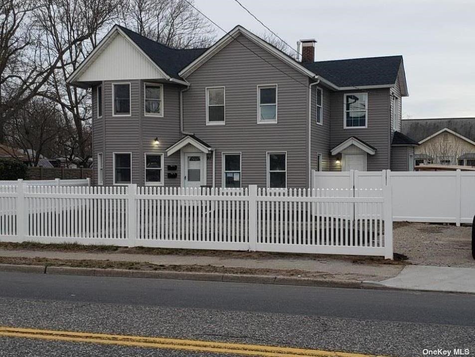 a front view of a house with a fence