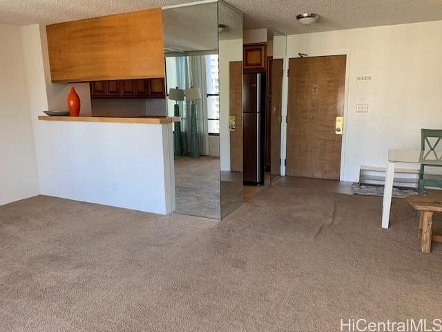 a view of kitchen with furniture and refrigerator