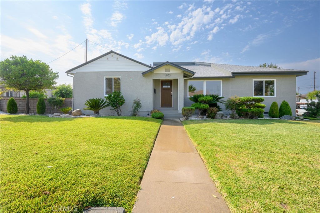 a front view of house with yard and green space