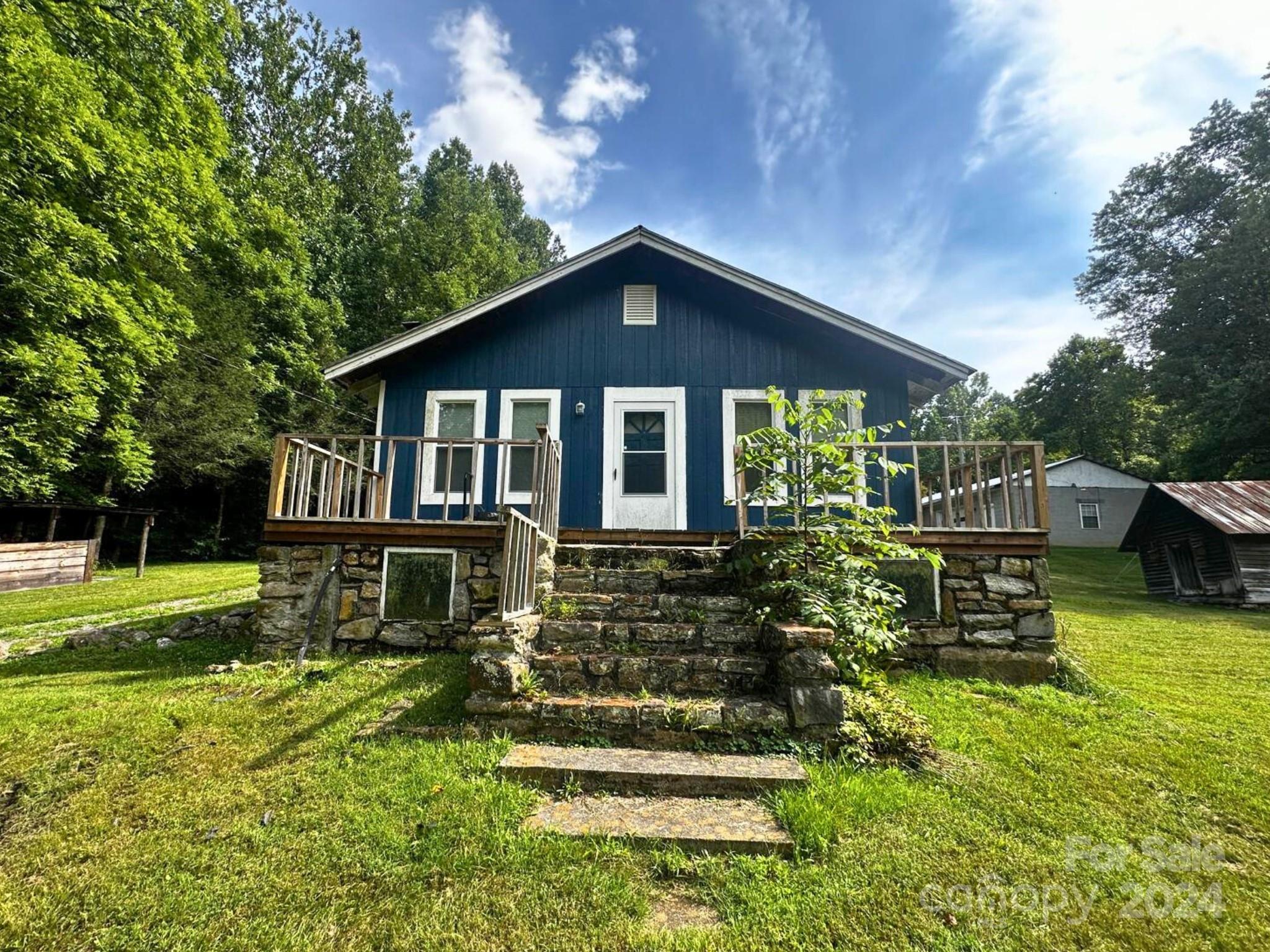 a front view of a house with a yard table and chairs