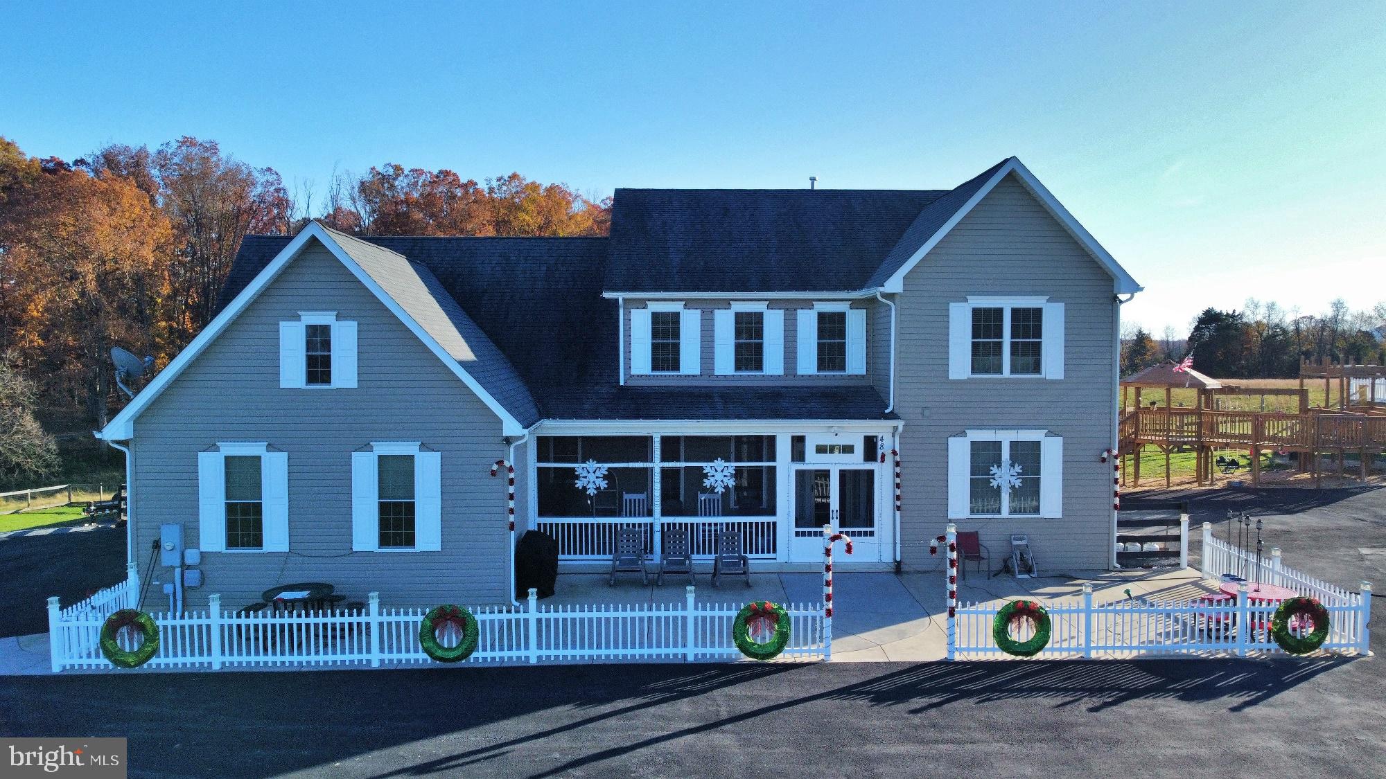 a front view of a house with sitting area