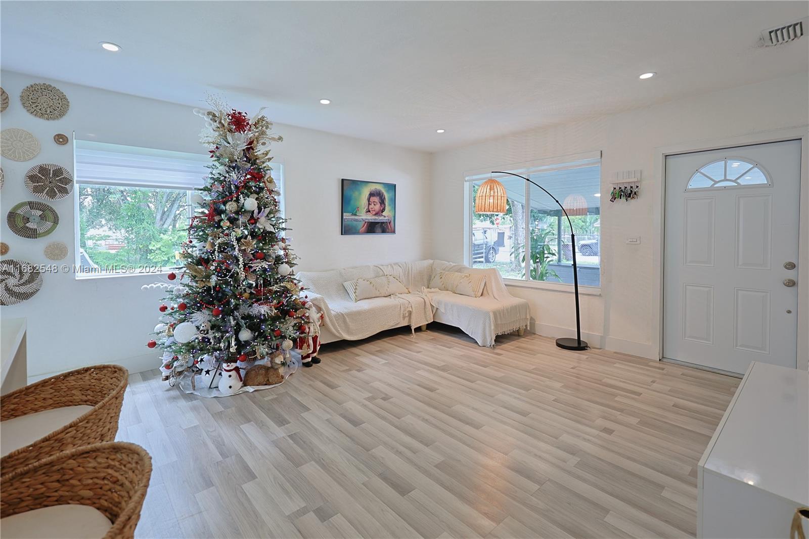 a living room with furniture and a christmas tree