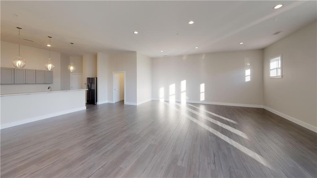 a view of a room wooden floor and windows in an empty room