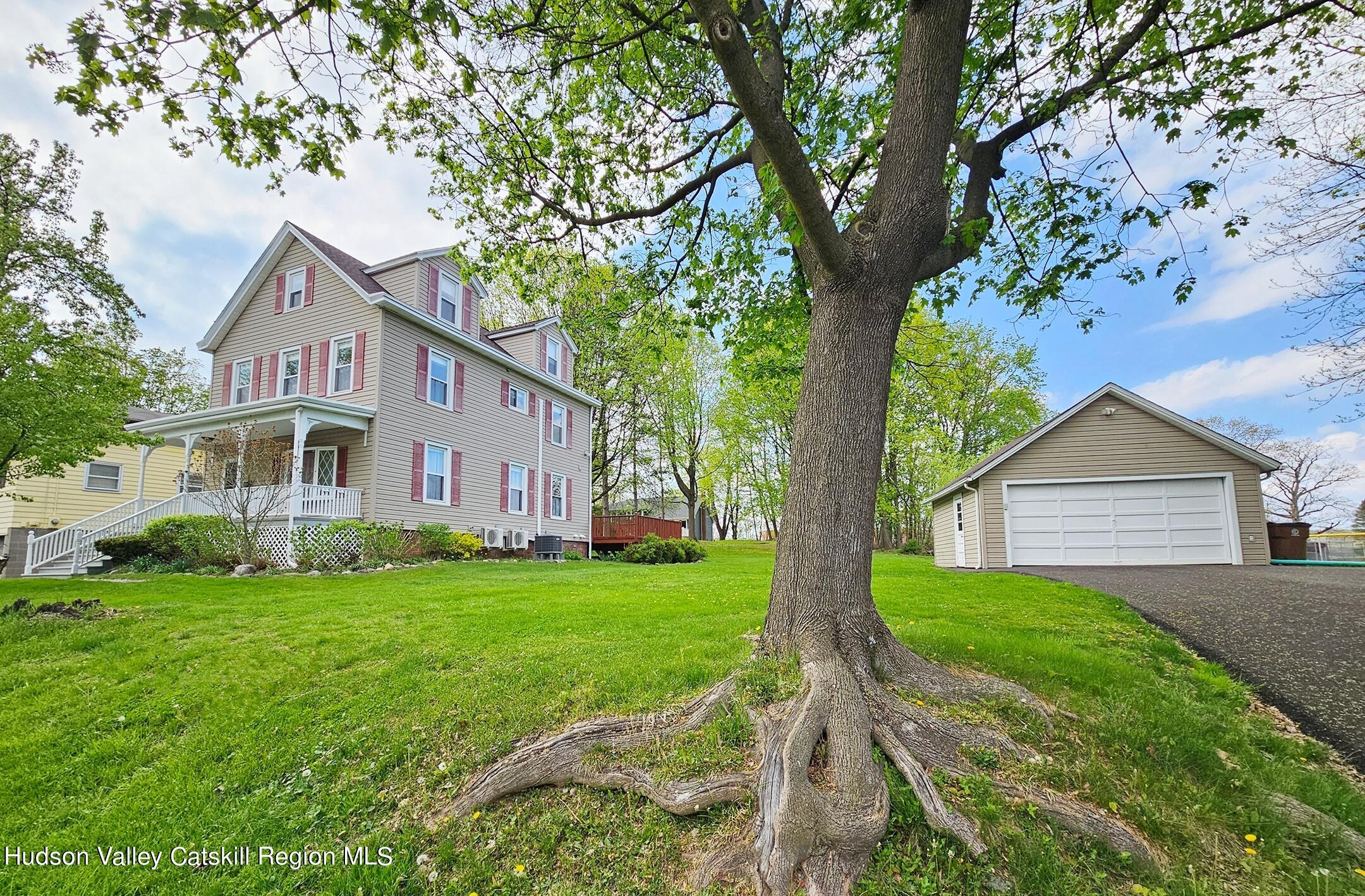 a front view of house with yard and green space