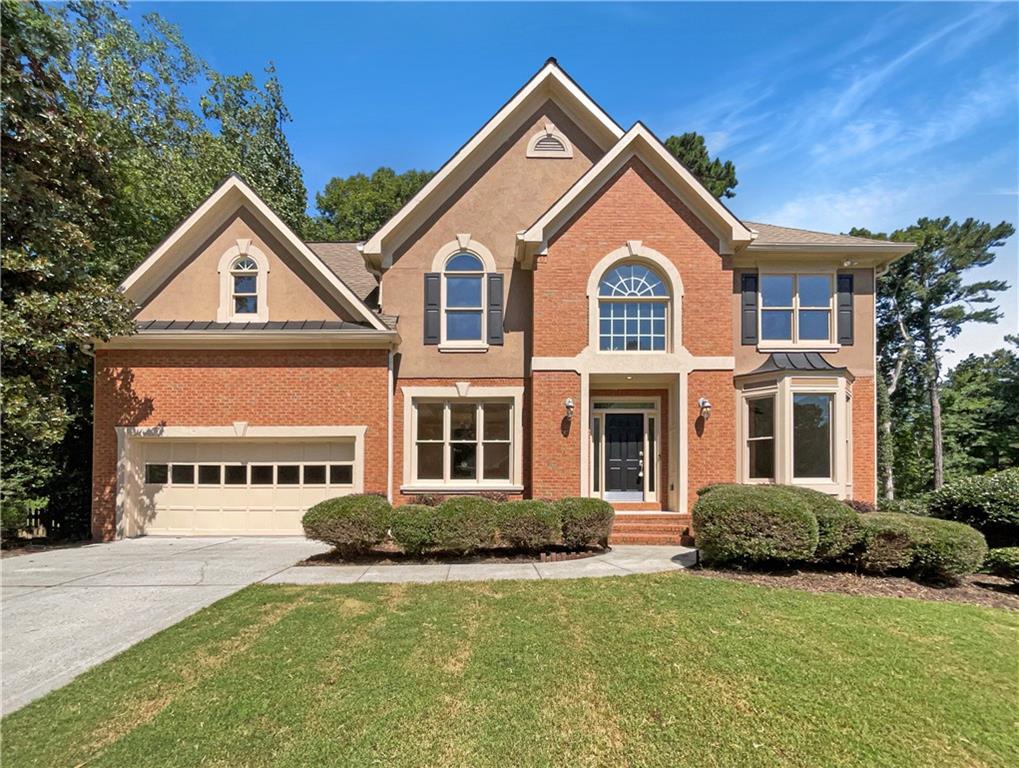 a front view of a house with a yard