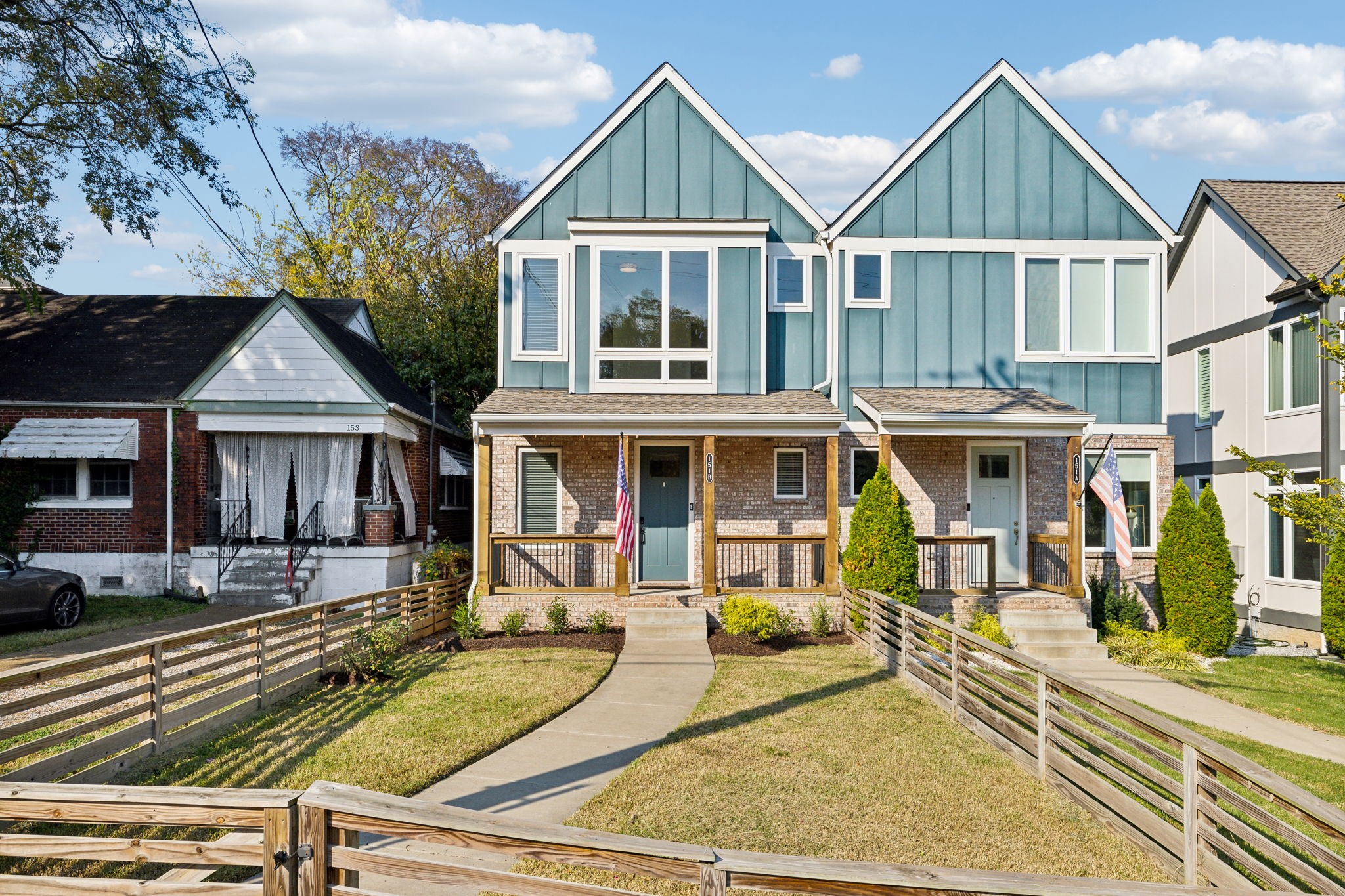 a view of a house with wooden fence